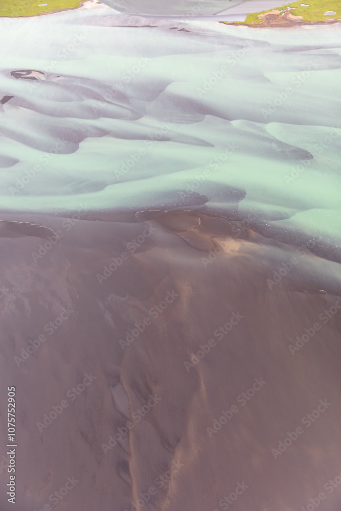 Fototapeta premium Glacial River in Iceland from above, top view, beautiful glacial runoff, mineral river