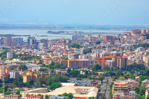 Obraz na płótnie Aerial panoramic view of Cagliari city in Sardinia, Italy. Vibrant city skyline featuring numerous buildings alongside sea w salonie