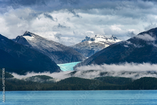 Ocean view of a snowcapped mountain with a river glacier in Alaska photo