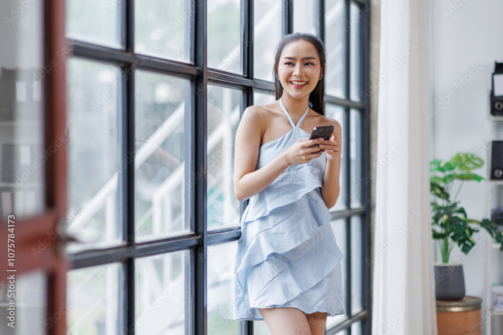 Cheerful beautiful Asian woman holding smartphone in the office workplace,
Cheerful beautiful Asian woman holding smartphone in the office workplace,