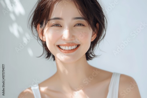 Smiling Japanese Woman with Short Hair in White Room