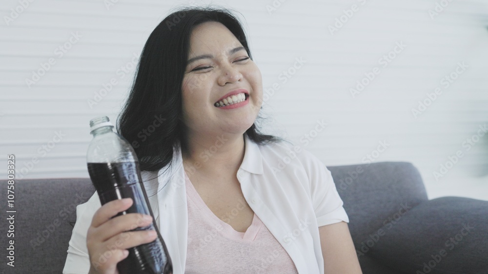 Fat woman drinks soda cola from plastic bottle Fat woman drinks soda cola from plastic bottle