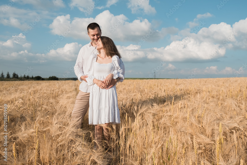 Romantic young couple standing in wheat field,Man and woman in wheat two Romantic young couple standing in wheat field,Man and woman in wheat two