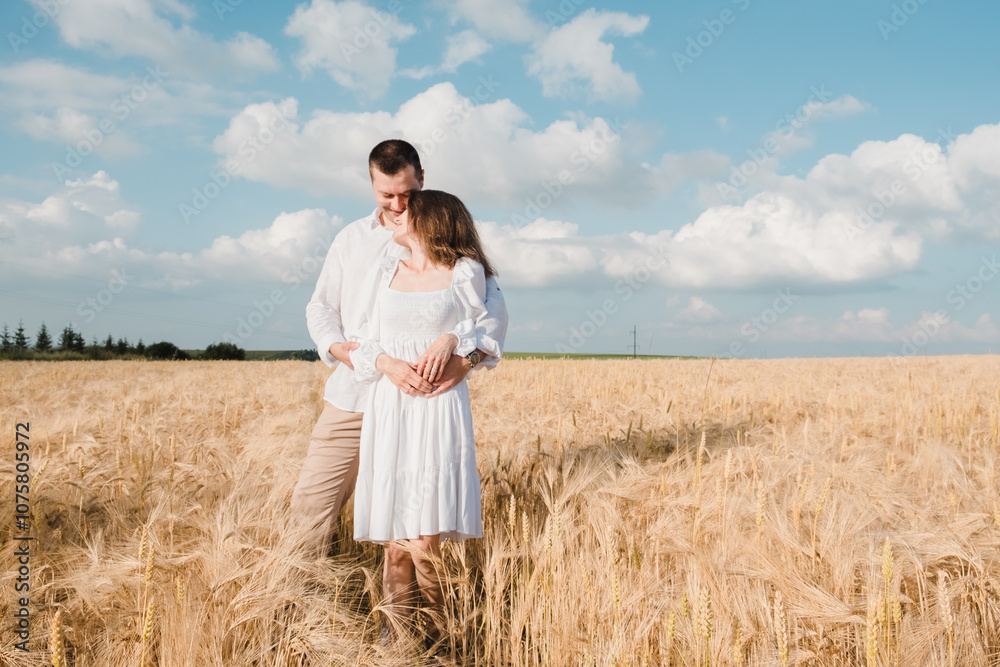 Romantic young couple standing in wheat field,Man and woman in wheat two Romantic young couple standing in wheat field,Man and woman in wheat two