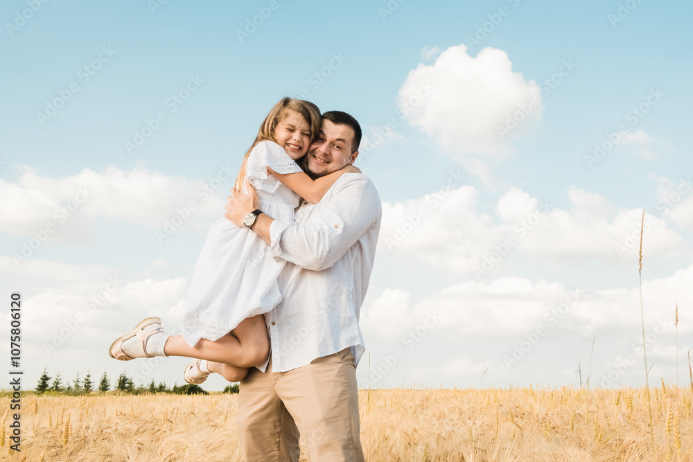farmer carries little daughter in his arms through a field of wheat. happy child and father are playing in field of ripening wheat. baby boy and dad travel on field. kid and parent play in nature. farmer carries little daughter in his arms through a field of wheat. happy child and father are playing in field of ripening wheat. baby boy and dad travel on field. kid and parent play in nature.