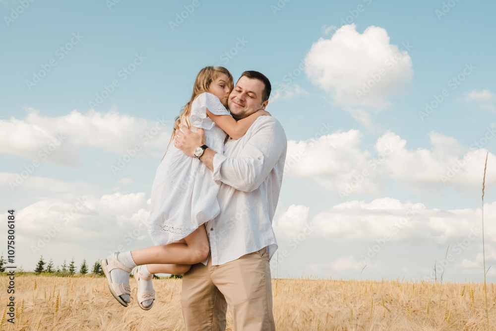 Dad with daughter in the field.Beautiful daughter kisses and hugs her dad. Dad with daughter in the field.Beautiful daughter kisses and hugs her dad.