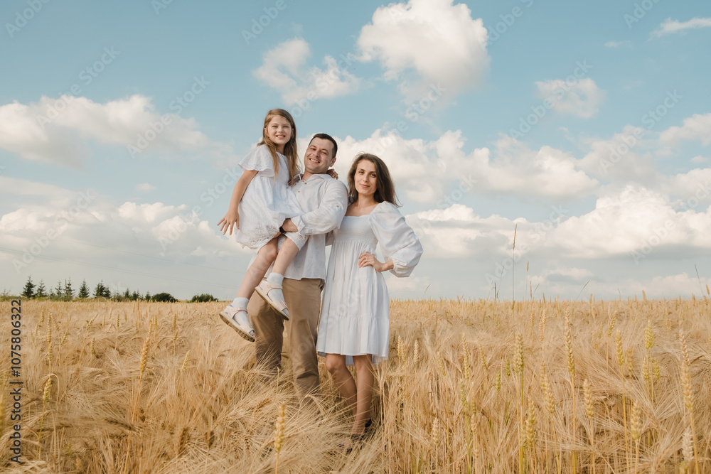 Farmer family with little daughter walking through wheat field. Mom dad daughter walking together holding hands. Farmer family with little daughter walking through wheat field. Mom dad daughter walking together holding hands.