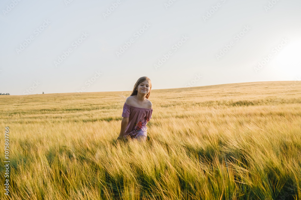 A very beautiful little girl.The child is smiling.Wheat field sunny day. A very beautiful little girl.The child is smiling.Wheat field sunny day.