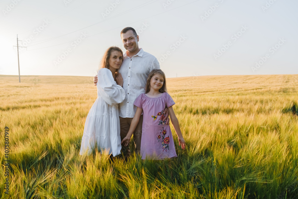 Love and happiness family together in wheat field.Family weekend concept. The loving family is on a picnic. The mother, dad and kid. Love and happiness family together in wheat field.Family weekend concept. The loving family is on a picnic. The mother, dad and kid.