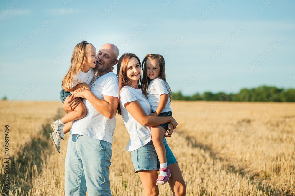 Family weekend concept. The loving family is on a picnic. The mother, dad and two kids.Children are having fun playing.Happy cheerful family in nature, weekend. Family weekend concept. The loving family is on a picnic. The mother, dad and two kids.Children are having fun playing.Happy cheerful family in nature, weekend.