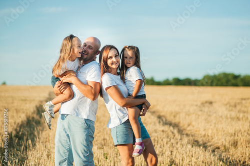 Family weekend concept. The loving family is on a picnic. The mother, dad and two kids.Children are having fun playing.Happy cheerful family in nature, weekend.