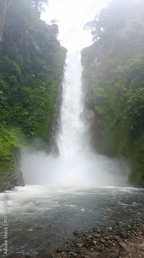 Majestic waterfall cascading down a rocky cliff into a misty pool of water. Majestic waterfall cascading down a rocky cliff into a misty pool of water.