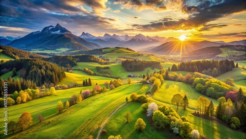 Breathtaking Drone Photography of a Vibrant Springtime Landscape Showcasing Grassy Fields, Rolling Hills, and Majestic Mountains Under a Clear Blue Sky