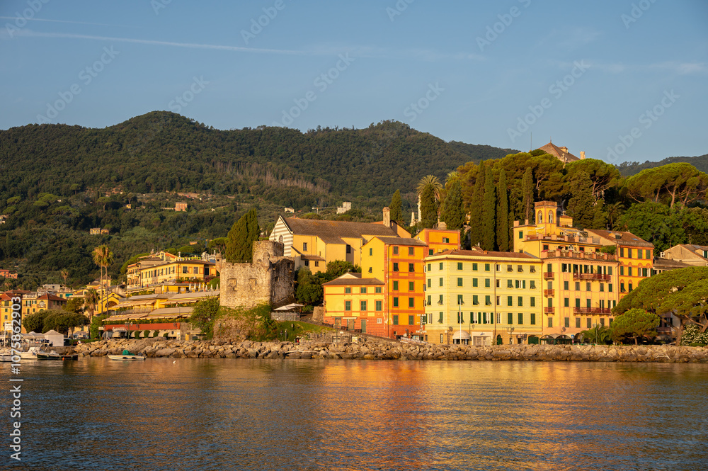 Fototapeta premium Early morning sun warming the buildings in the Italian harbor of Santa Margherita.