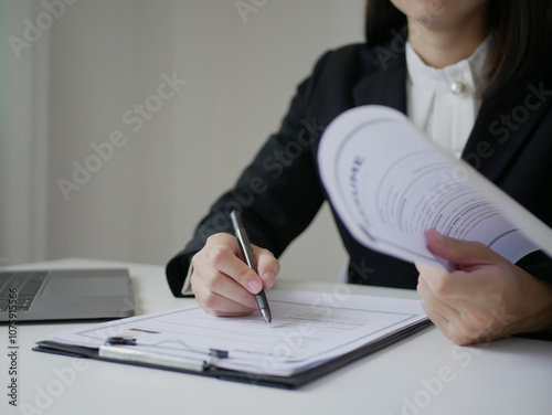 Businesswoman employer holding resume of job applicant to analyze data before job interview, recruit new employee, about recruitment