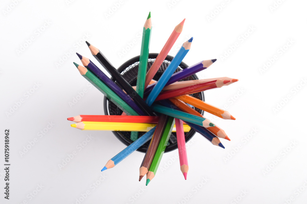 Colorful pencils in metal basket isolated on white background. Colorful pencils in container or pencil box. Education or back to school concept Colorful pencils in metal basket isolated on white background. Colorful pencils in container or pencil box. Education or back to school concept