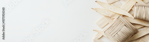 Natural Textured Background Featuring Strips of Light-Colored Leaves and Intricately Weaved Patterns on a White Surface for Design and Craft Use