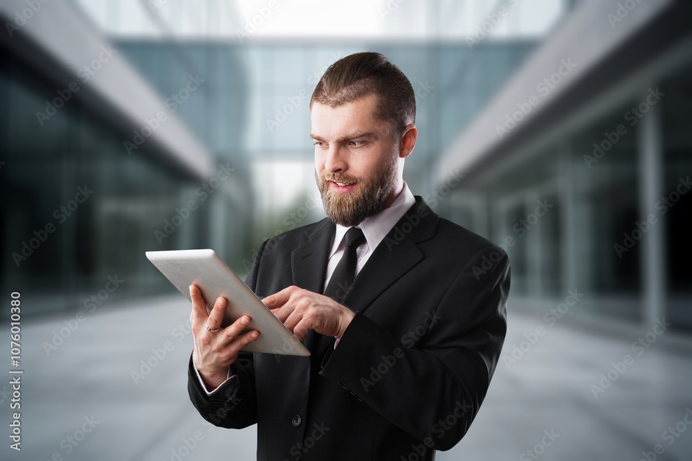 Confident business man using digital tablet outdoors Confident business man using digital tablet outdoors