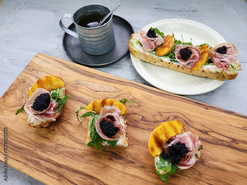 Delicious homemade pastry. Smoked Rolled Bacon Baguette with Cream Cheese, Herbs and Black Caviar. Ideal for family gatherings photo