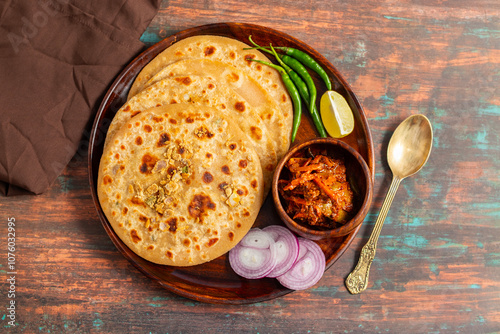 Sattu paratha, a nutritious flatbread from Uttar Pradesh and Bihar, stuffed with roasted gram flour, served with pickle and raita. photo