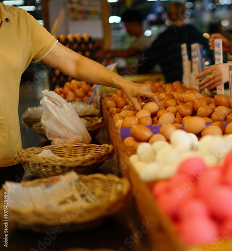 A large number of eggs on a tray that customers are selecting to be sent to the vendor to be packaged.