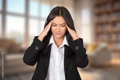 Stressed woman suffering from headache at home photo