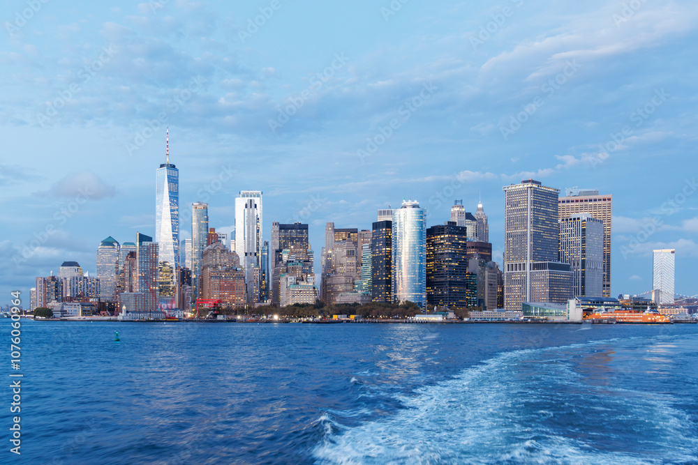 Fototapeta premium A vibrant sunset panorama of Manhattan downtown skyline, viewed from the river