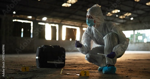 Woman, swab and murder investigation at crime scene, blood sample and discovery of dna marker. Female person, homicide evidence and hazmat suit for safety, abandoned building and search for clues photo