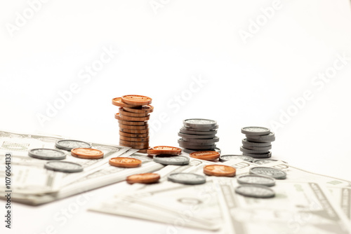 US coin and paper currency ascending like a bar graph isolated on white table