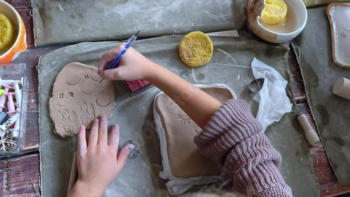 Workshop for kids. Children learning how to use clay for making beautiful dishes. Workshop, master class.
