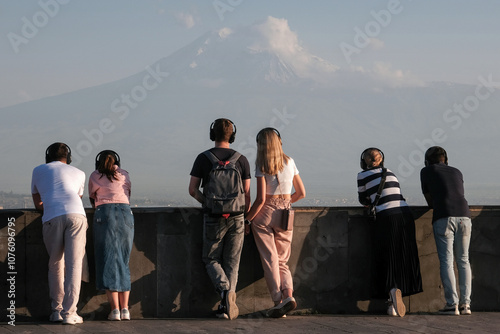 Tourists looking at Mount Ararat from Cascade Complex view point at summer sunset. Yerevan, Armenia.