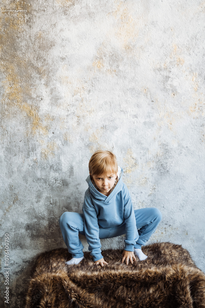A little boy, full of joy and happiness, is sitting comfortably on a soft pile of fur, enjoying the moment in his playful and carefree manner as he explores his surroundings A little boy, full of joy and happiness, is sitting comfortably on a soft pile of fur, enjoying the moment in his playful and carefree manner as he explores his surroundings