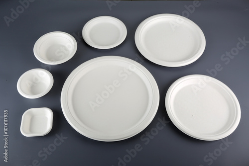 Biodegradable disposable tableware plates, glasses and spoons with forks on close-up Trend ecology plastic free
