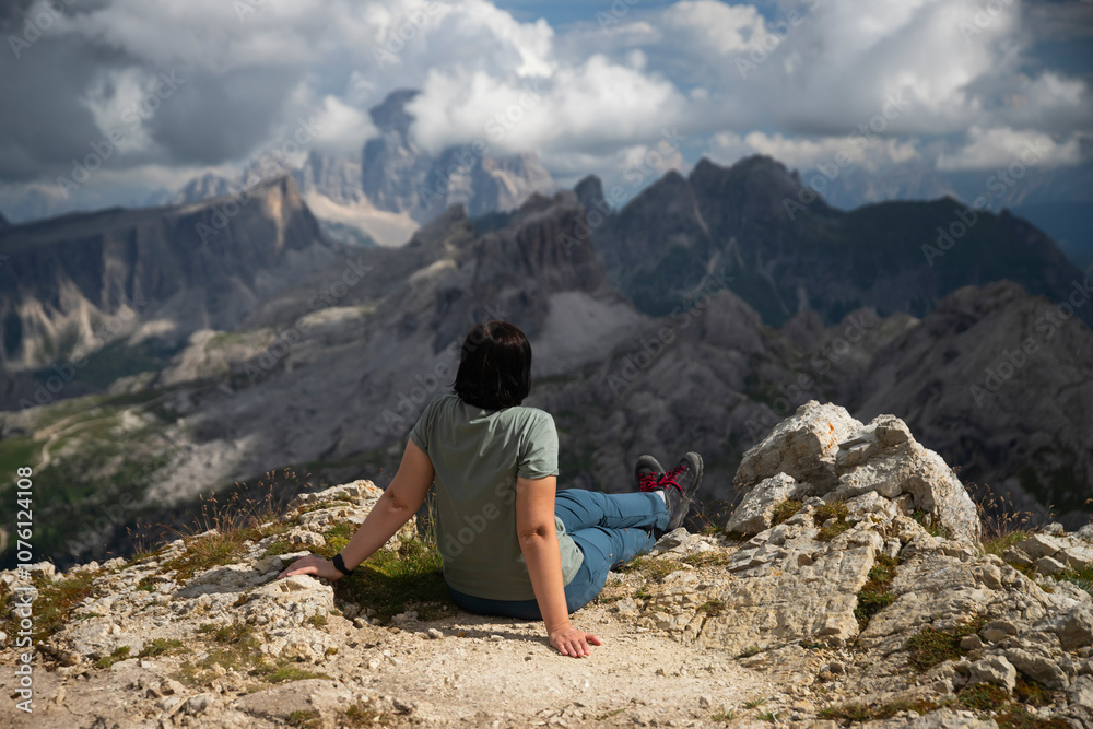 Naklejka premium Hiker woman enjoys the view from Lagazuoi mountain over the italian Dolomites.