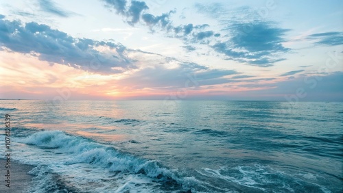 Soft blue watercolor background with a subtle ocean sunset, waves, soft blue