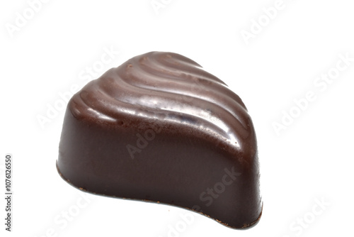 A chocolate candy in the shape of a drop of water lies on a white background.