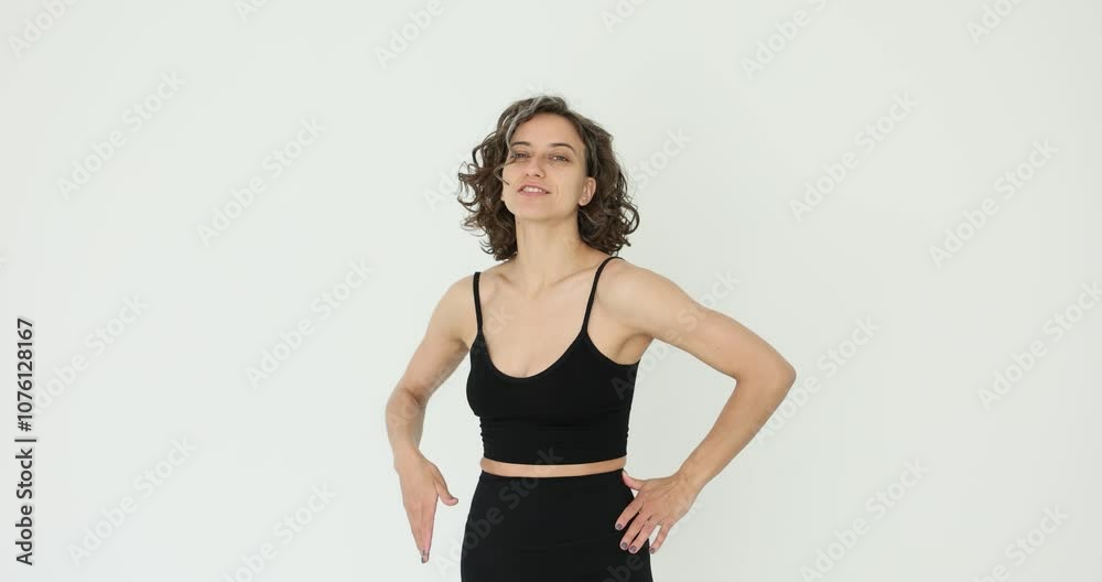 Confident sporty beautiful smiling woman posing on white background