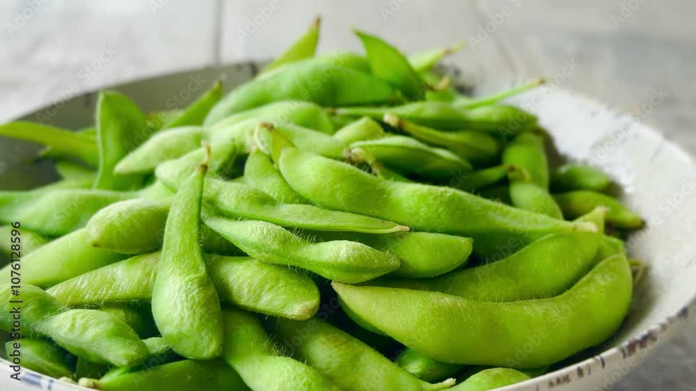 Edamame beans in ceramic bowl, soybeans, selective focus.
Edamame beans in ceramic bowl, soybeans, selective focus.