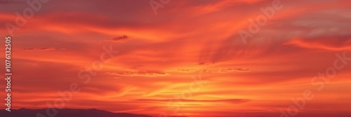 Sunset sky with deep orange and purple hues bleeding into each other on a soft watercolor background featuring gentle wisps of clouds, hues, soft, sky