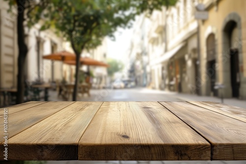 Empty wooden table in front of a blurred outdoor cafe scene.