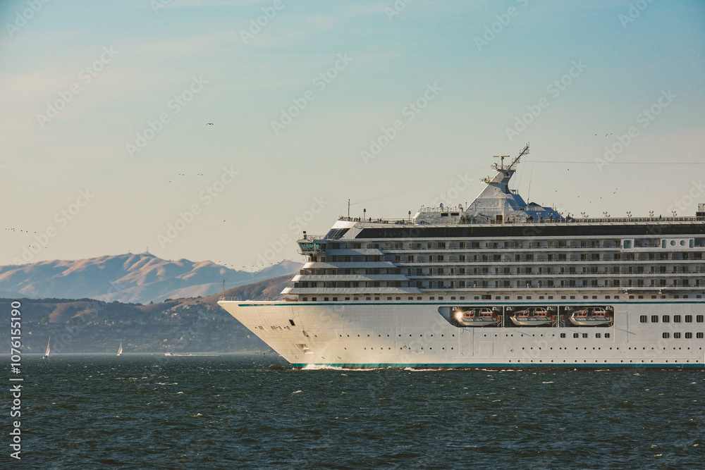 Luxury cruiseship cruise ship liner Serenity sail away departure from San Francisco port through bay towards Golden Gate Bridge on sunny day Luxury cruiseship cruise ship liner Serenity sail away departure from San Francisco port through bay towards Golden Gate Bridge on sunny day