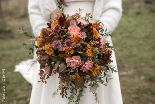 Bride Holding Colorful Autumn Bouquet Outdoors