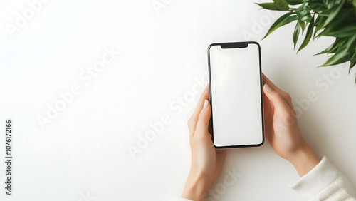 Hand holding a modern smartphone with blank screen. Smartphone mockup template