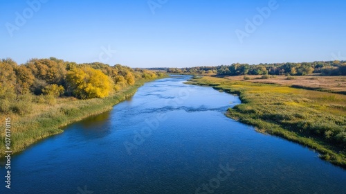 Aerial view of a river under a clear blue sky captured by a drone, emphasizing the beauty of the river landscape with ample photo space for creative use. photo