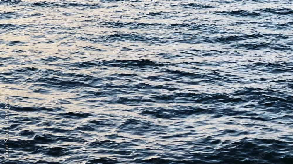 Closeup seascape surface of blue sea water with small ripple waves Closeup seascape surface of blue sea water with small ripple waves