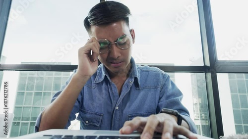 Business man feeling discomfort and eye strain after using computer long times and taking off glasses.