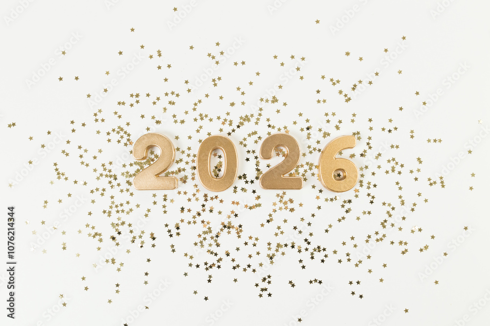 2026 Happy New Year. Top view of gold numbers, gold stars confetti on white background. Copy space, flat lay. 2026 Happy New Year. Top view of gold numbers, gold stars confetti on white background. Copy space, flat lay.