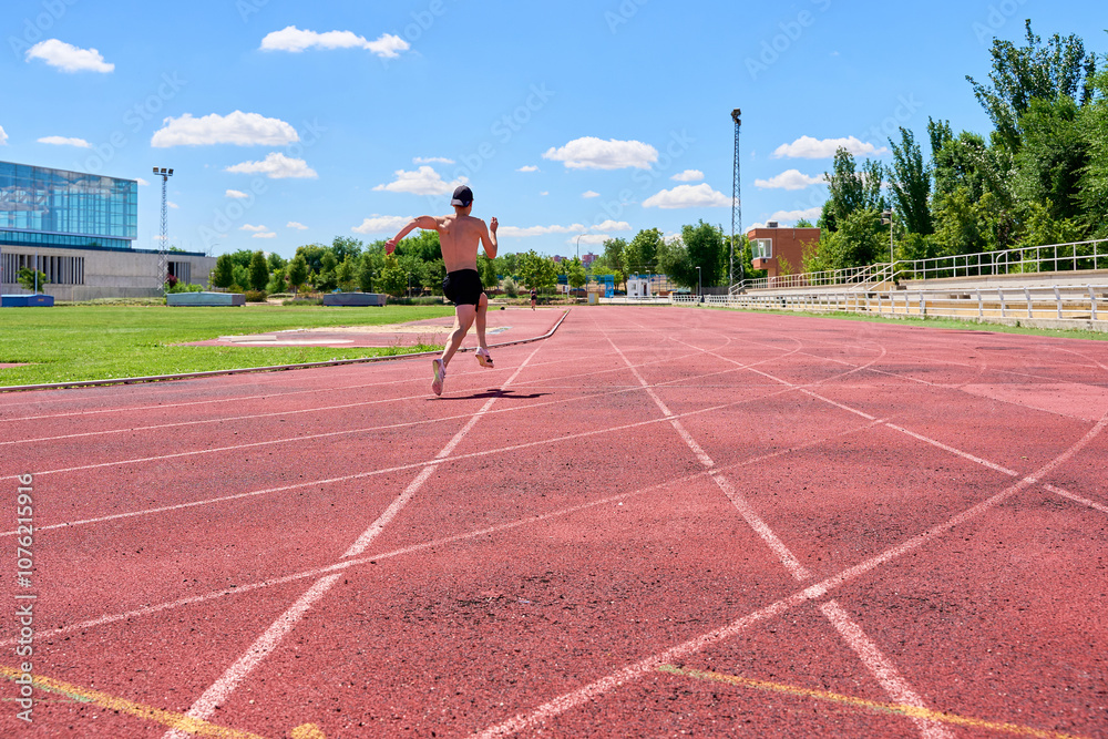 Sprinter running on track during solo training Sprinter running on track during solo training