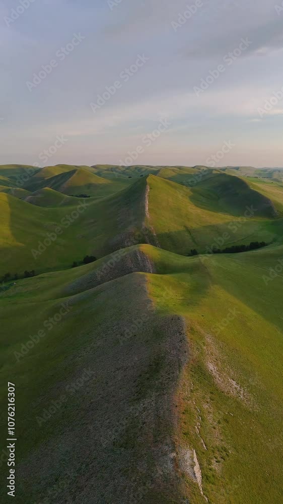 flying over textured green mountains in the Orenburg region