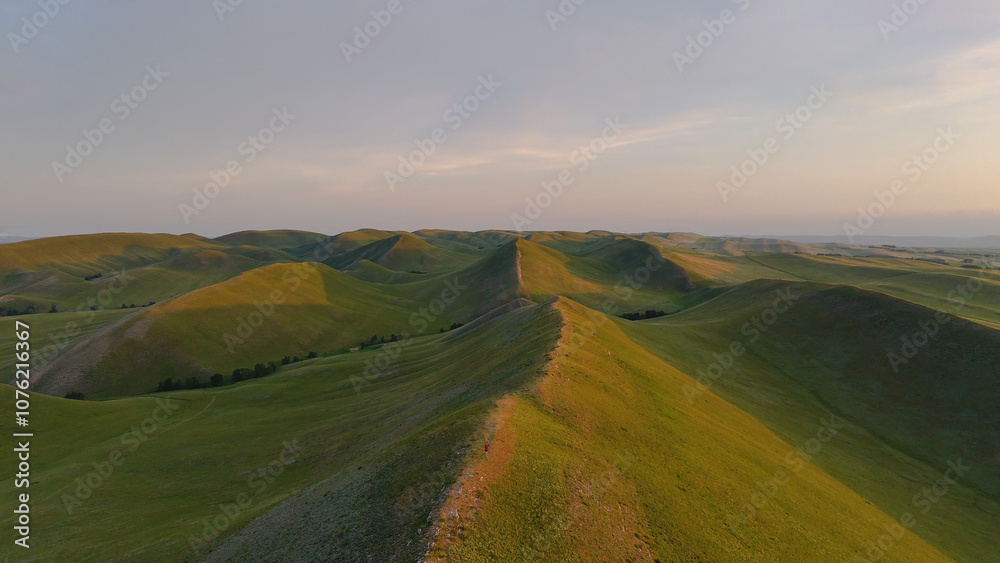 Obraz premium flying over textured green mountains in the Orenburg region